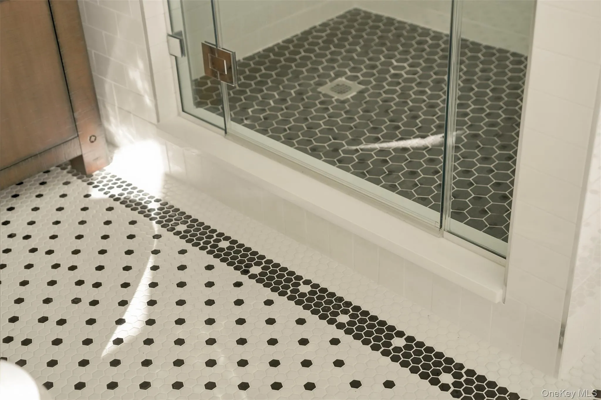 Traditional tile choices including black and white in the primary ensuite Traditional tile choices including black and white in the primary ensuite