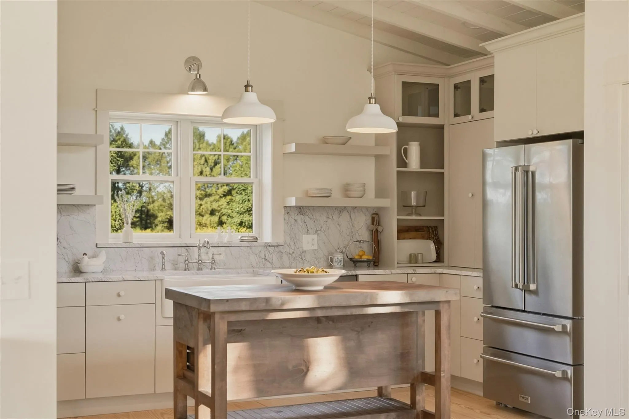 Soft, creamy colors and classic design choices make this kitchen stand out. It is ready for your next gathering. Carrara marble countertops. Thor appliances. Aster island. Exposed wood beams. Soft, creamy colors and classic design choices make this kitchen stand out. It is ready for your next gathering. Carrara marble countertops. Thor appliances. Aster island. Exposed wood beams.