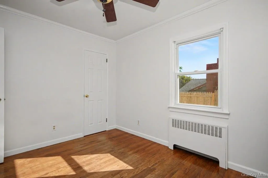 Bedroom on first floor has a ceiling fan with light Bedroom on first floor has a ceiling fan with light