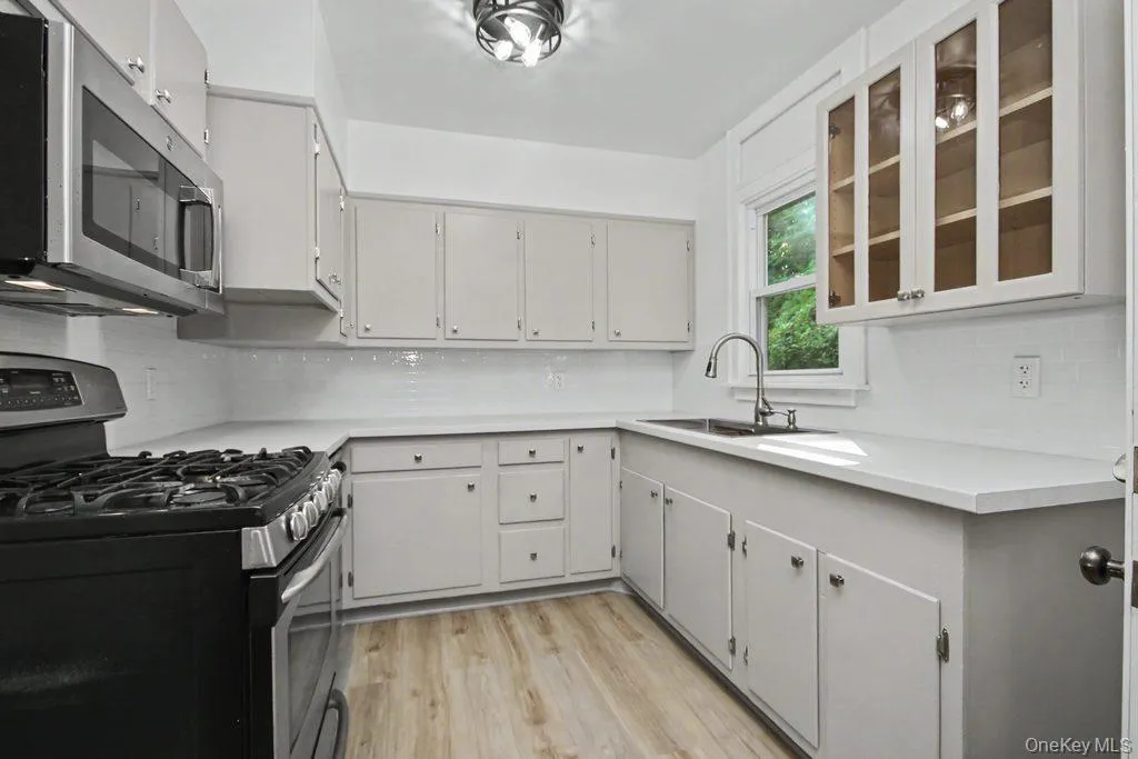 Kitchen has subway tile and built in microwave Kitchen has subway tile and built in microwave