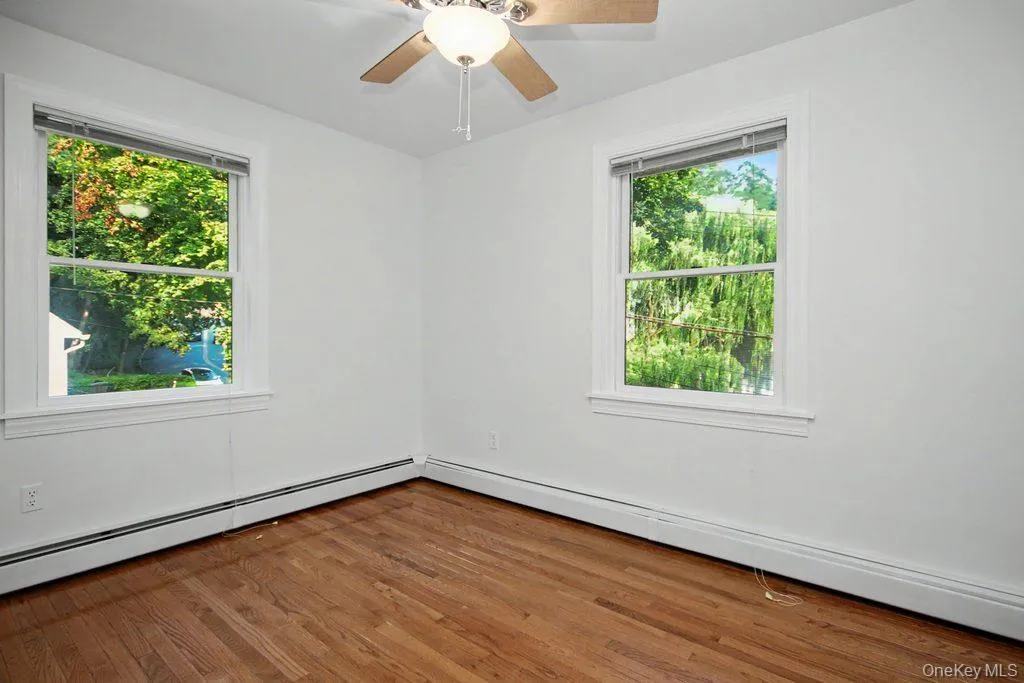 Third Bedroom has hardwood floors and ceiling fan with light Third Bedroom has hardwood floors and ceiling fan with light
