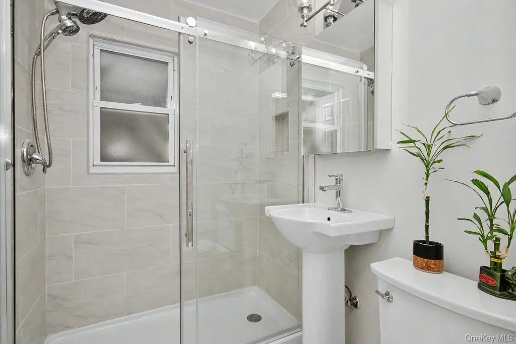 Updated bathroom with oversized shower and pedestal sink Updated bathroom with oversized shower and pedestal sink