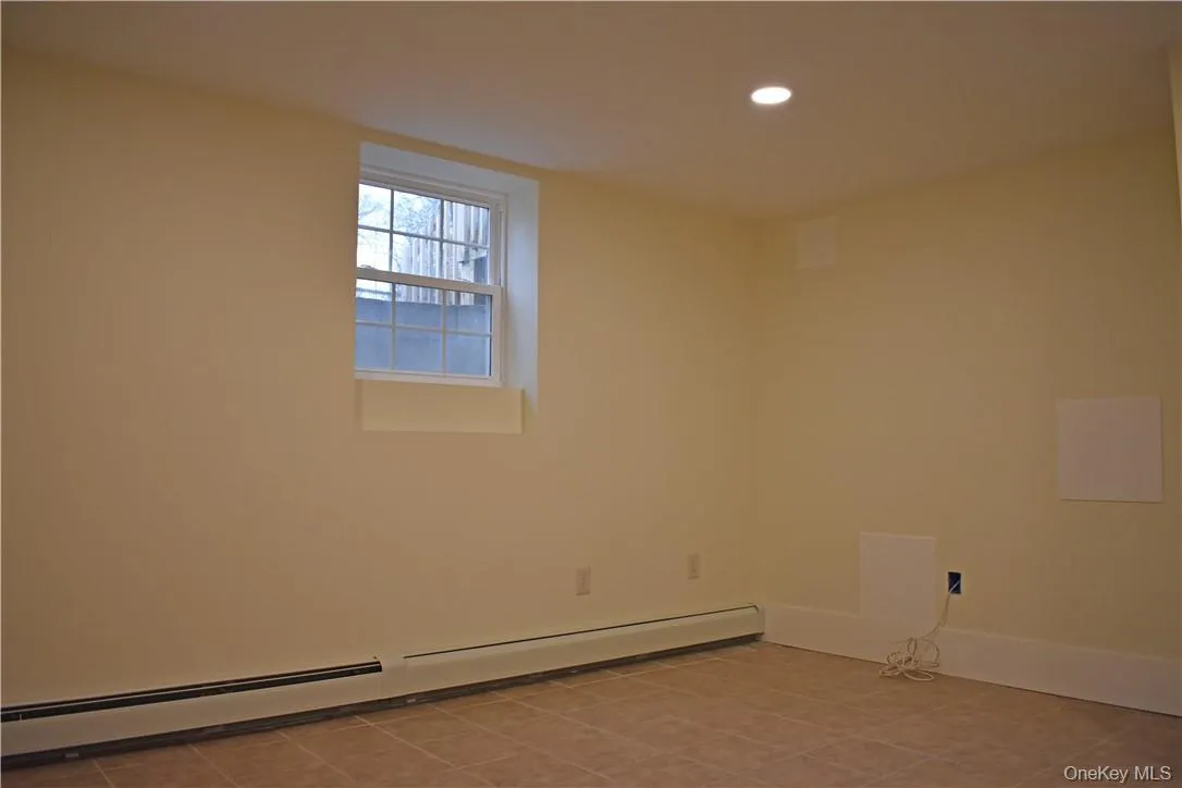 Recessed ceiling lighting, tiled flooring, window with white trim, baseboard heating Recessed ceiling lighting, tiled flooring, window with white trim, baseboard heating