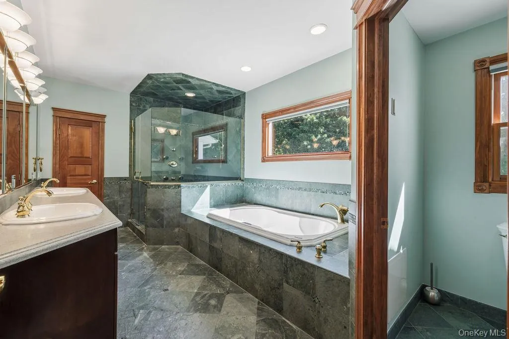 Jetted tub, tiled shower, two sinks, private toilet stall Jetted tub, tiled shower, two sinks, private toilet stall