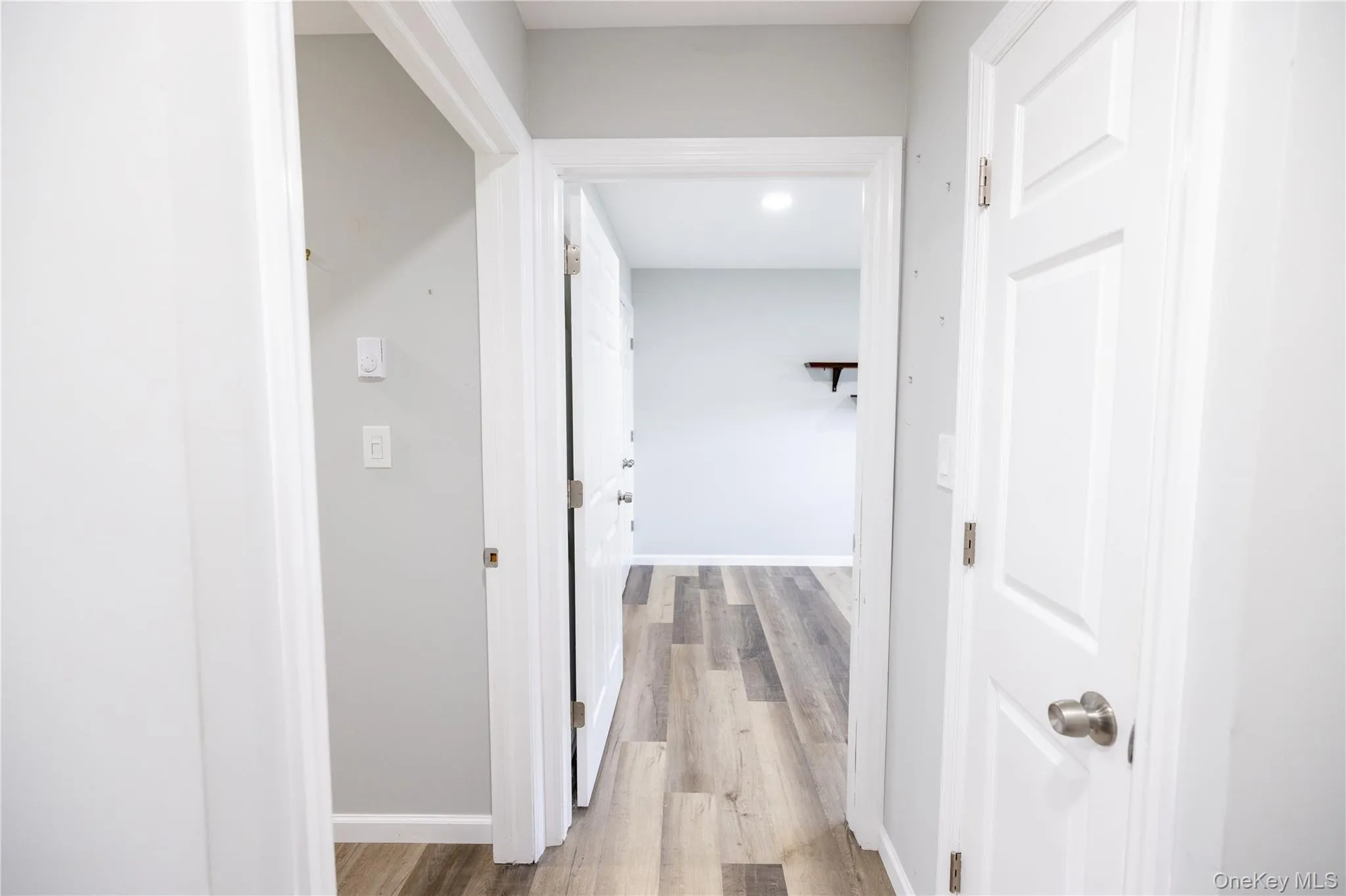 Wood-finish flooring throughout, white paneled doors, and recessed ceiling lighting Wood-finish flooring throughout, white paneled doors, and recessed ceiling lighting