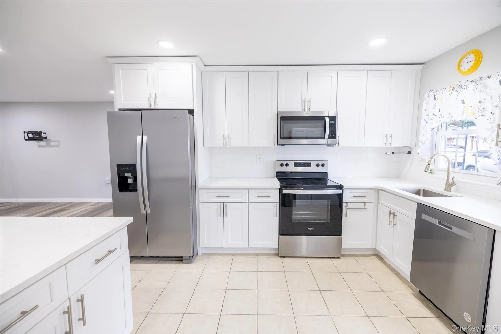 White cabinetry, stainless steel appliances, and light-toned countertops White cabinetry, stainless steel appliances, and light-toned countertops