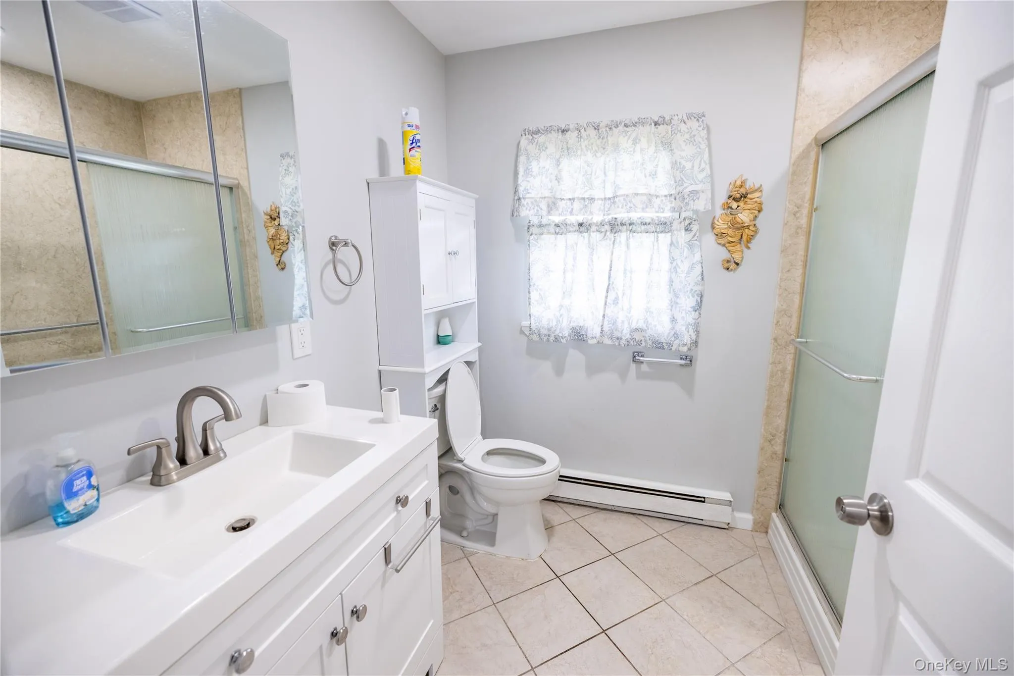 White vanity with integrated sink, brushed nickel faucet, and coordinating hardware White vanity with integrated sink, brushed nickel faucet, and coordinating hardware