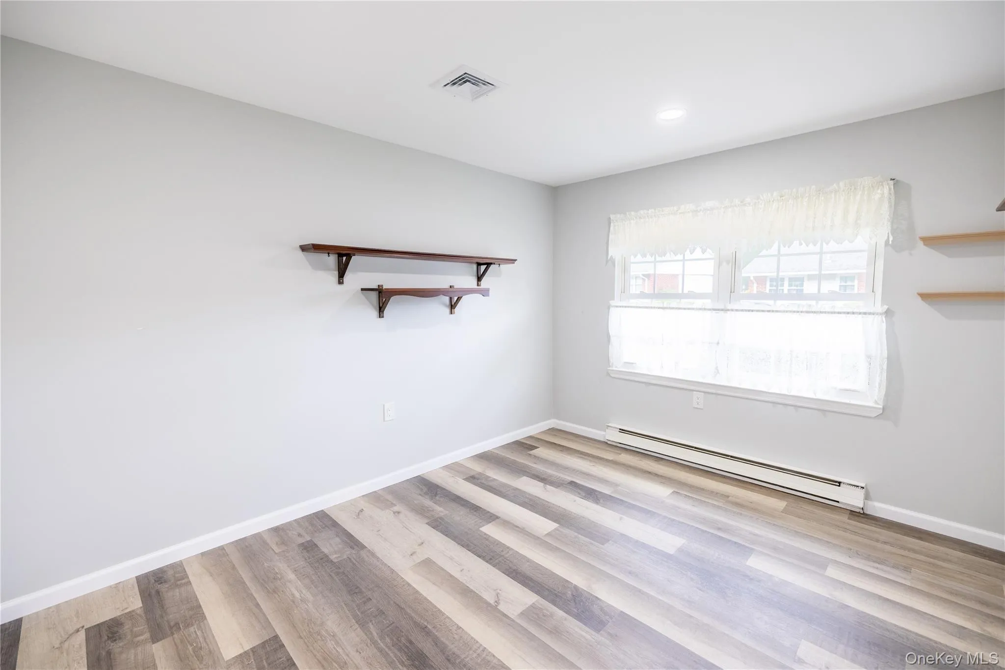Wood-finish flooring, recessed lighting, and wall-mounted shelving Wood-finish flooring, recessed lighting, and wall-mounted shelving