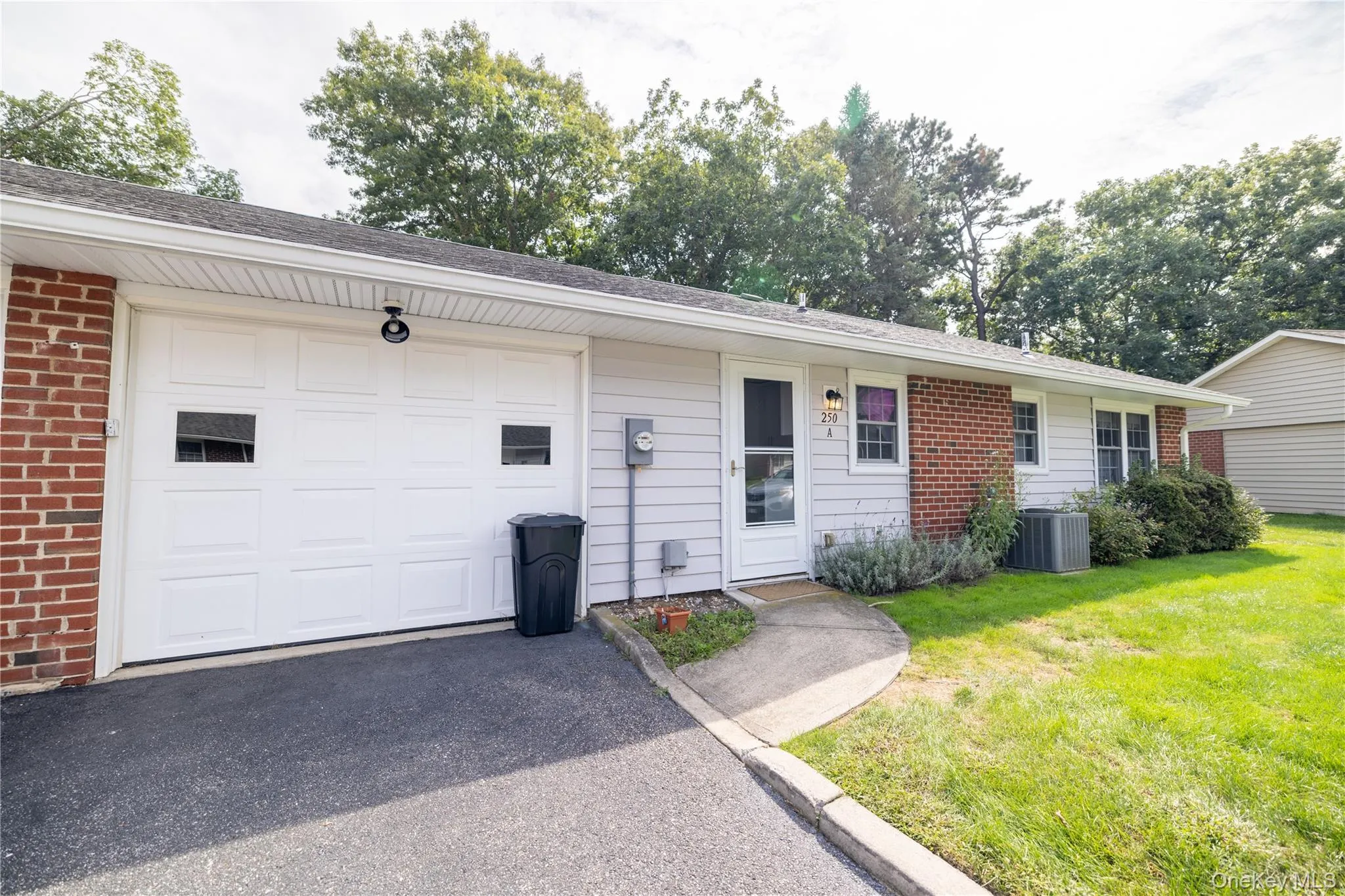 White paneled garage door with square window inserts in the Rear exterior White paneled garage door with square window inserts in the Rear exterior