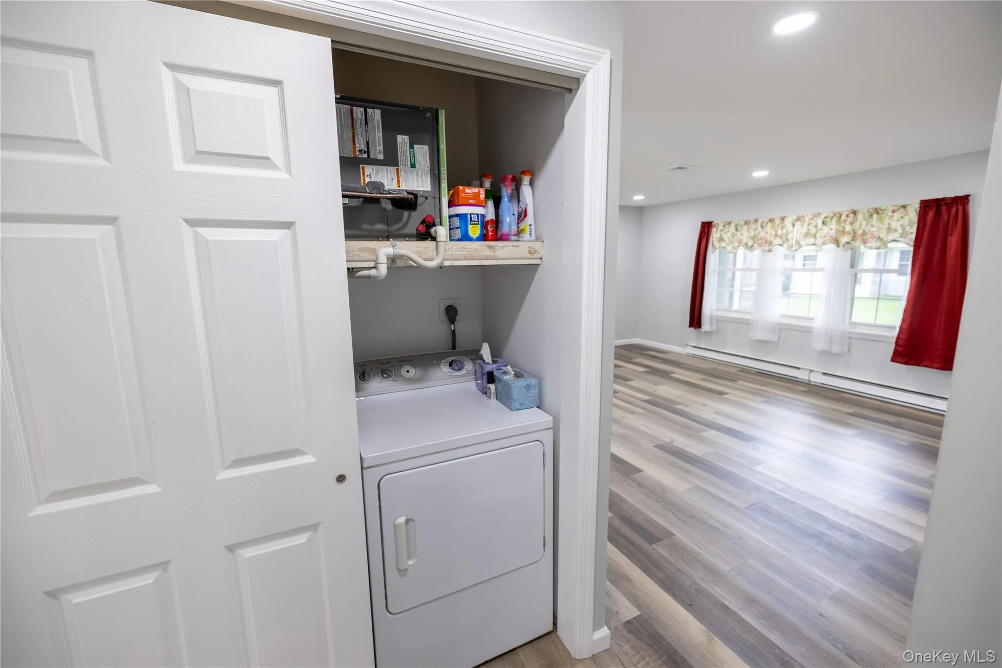 Dedicated laundry closet with built-in shelving Dedicated laundry closet with built-in shelving