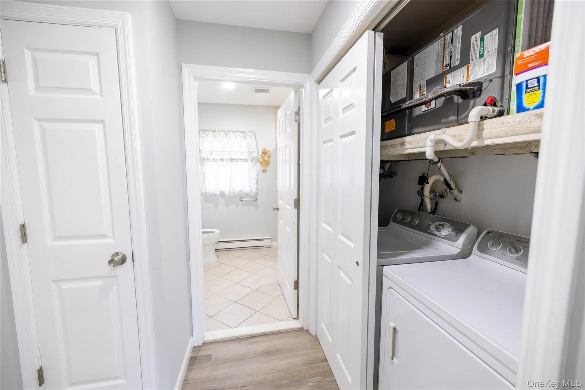 Dedicated laundry closet with white appliances Dedicated laundry closet with white appliances