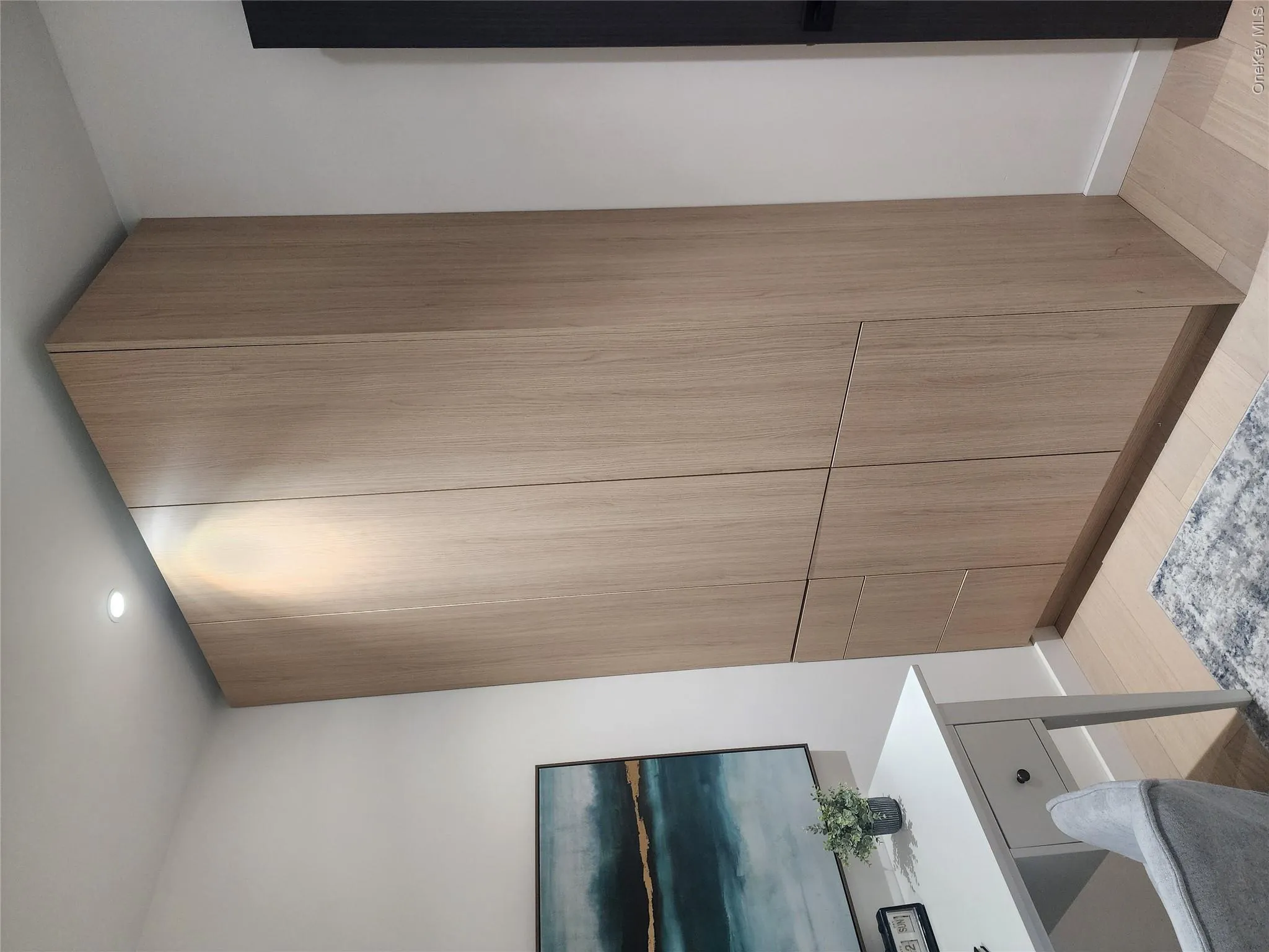 Built-in cabinetry with wood-finish doors and integrated drawers Built-in cabinetry with wood-finish doors and integrated drawers