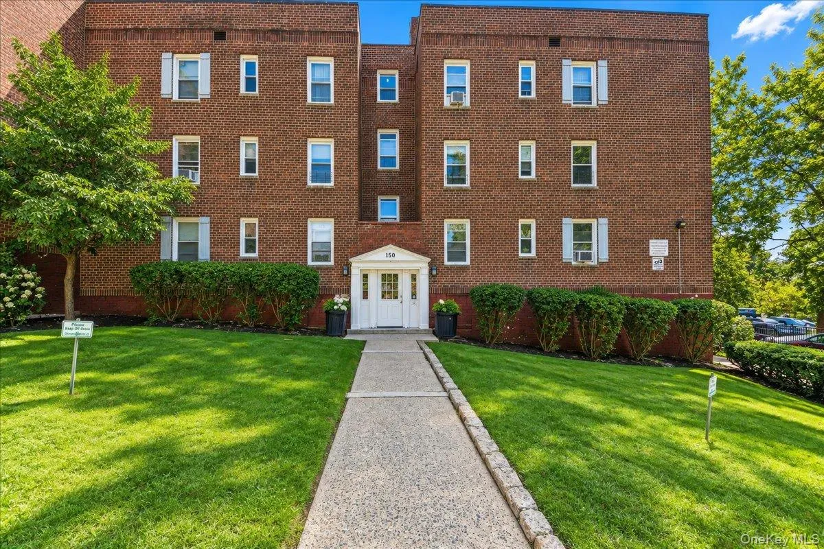 Brick exterior with white window shutters and a white entryway Brick exterior with white window shutters and a white entryway