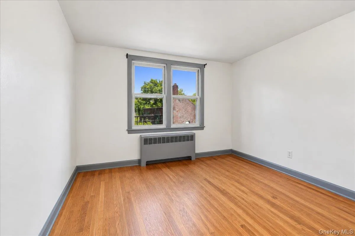 Hardwood flooring, painted trim, painted window frames, and baseboard heating Hardwood flooring, painted trim, painted window frames, and baseboard heating