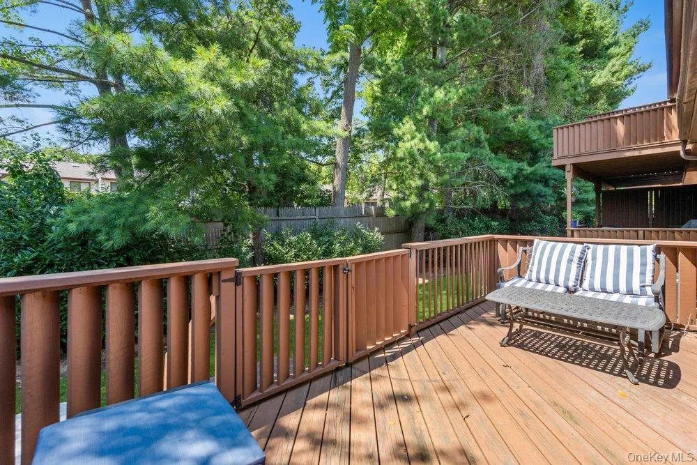 Expansive wood deck with a built-in privacy gate and railings Expansive wood deck with a built-in privacy gate and railings
