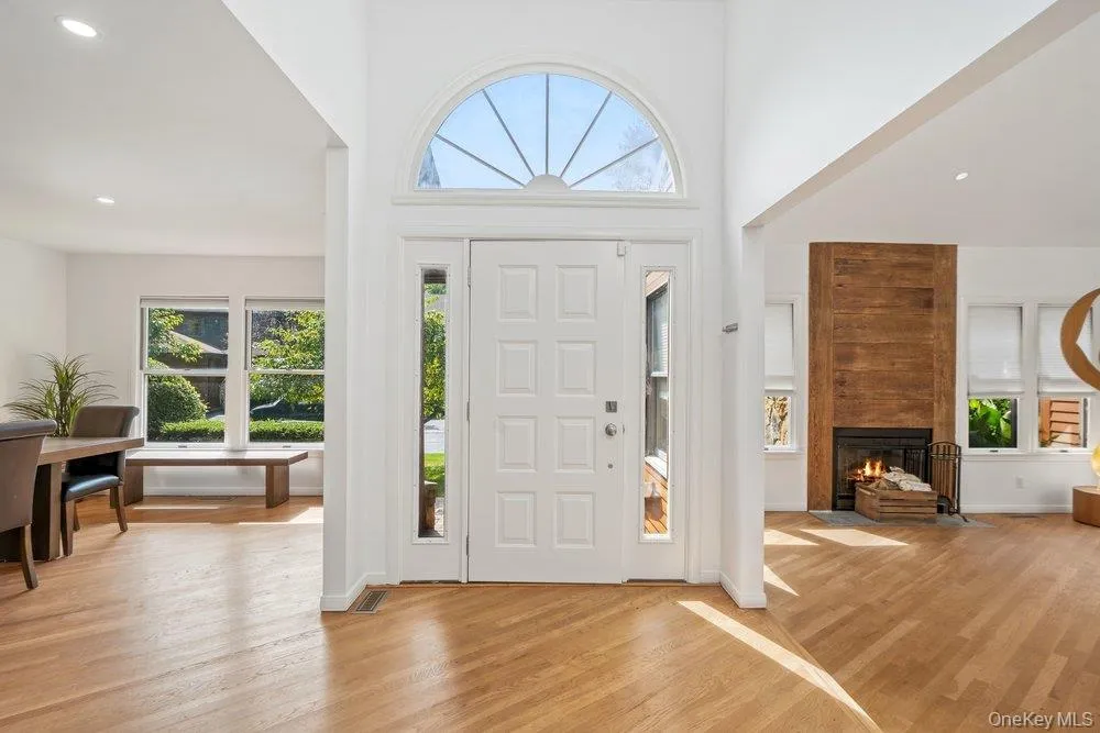 Two-story foyer with transom window, sidelights, and paneled entry door Two-story foyer with transom window, sidelights, and paneled entry door