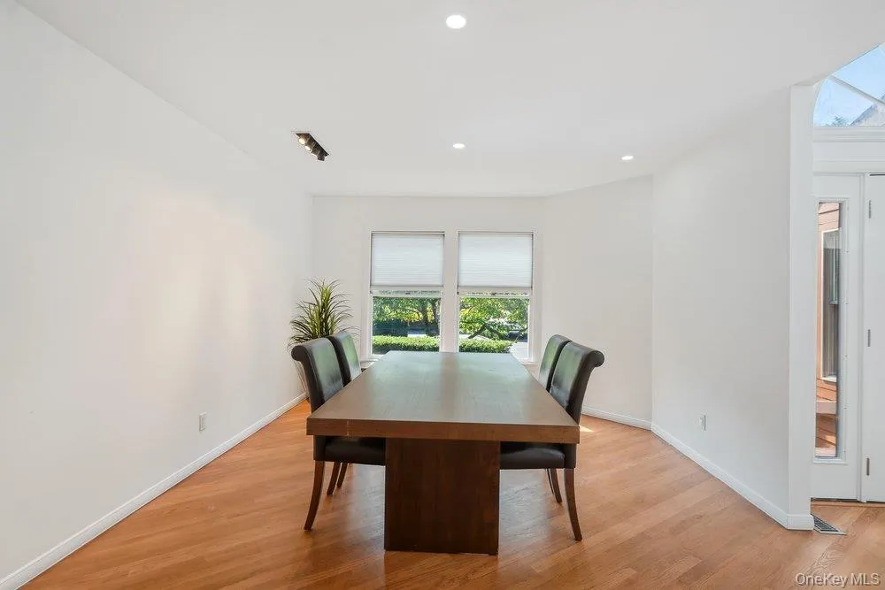 Hardwood flooring throughout, recessed ceiling lighting, and a bay window Hardwood flooring throughout, recessed ceiling lighting, and a bay window