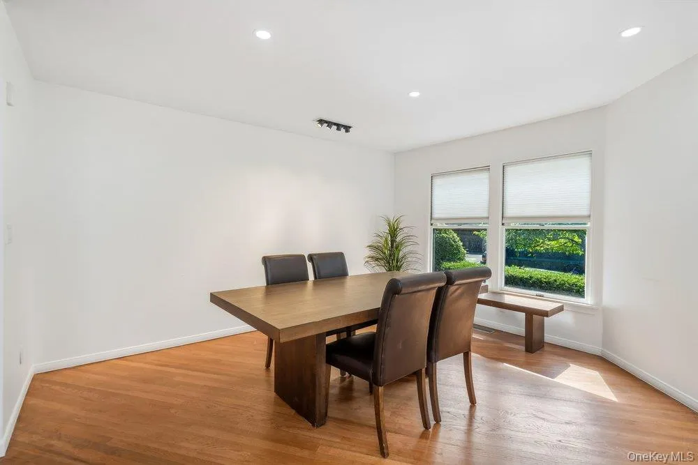 Hardwood flooring, recessed lighting, and dual windows with blinds Hardwood flooring, recessed lighting, and dual windows with blinds