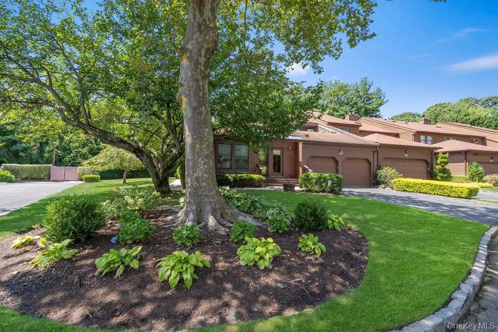 Mature trees, manicured lawn, established landscaping, attached garages, and a private driveway Mature trees, manicured lawn, established landscaping, attached garages, and a private driveway