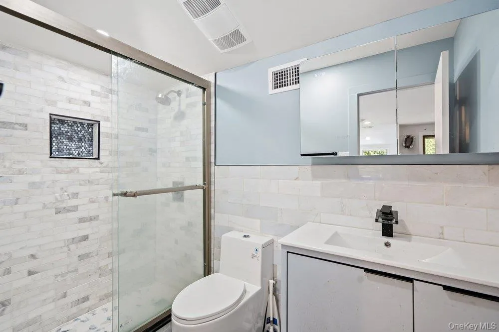 Glass-enclosed shower with subway tile surround and recessed niche Glass-enclosed shower with subway tile surround and recessed niche
