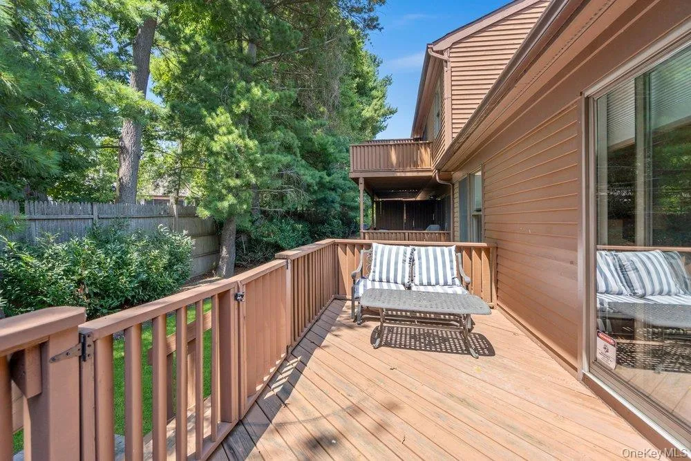 Expansive wooden deck with coordinating railings and a functional gate Expansive wooden deck with coordinating railings and a functional gate