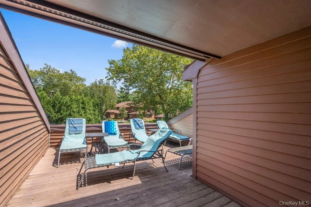 Expansive outdoor deck with wood flooring and privacy walls Expansive outdoor deck with wood flooring and privacy walls