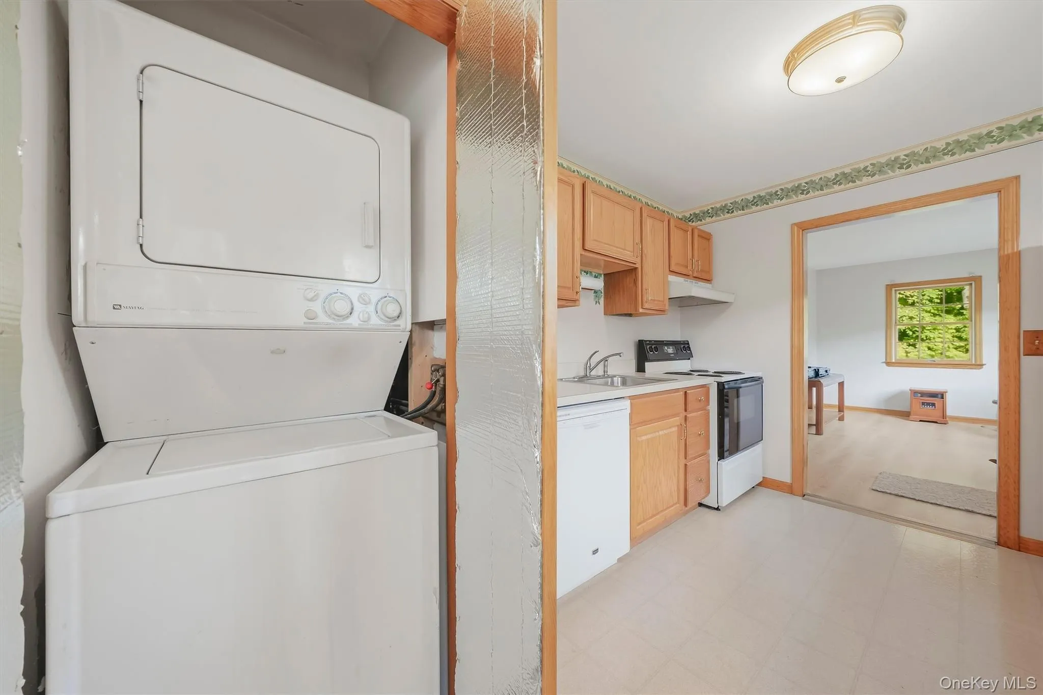 Laundry is tucked away in kitchen closet. Laundry is tucked away in kitchen closet.
