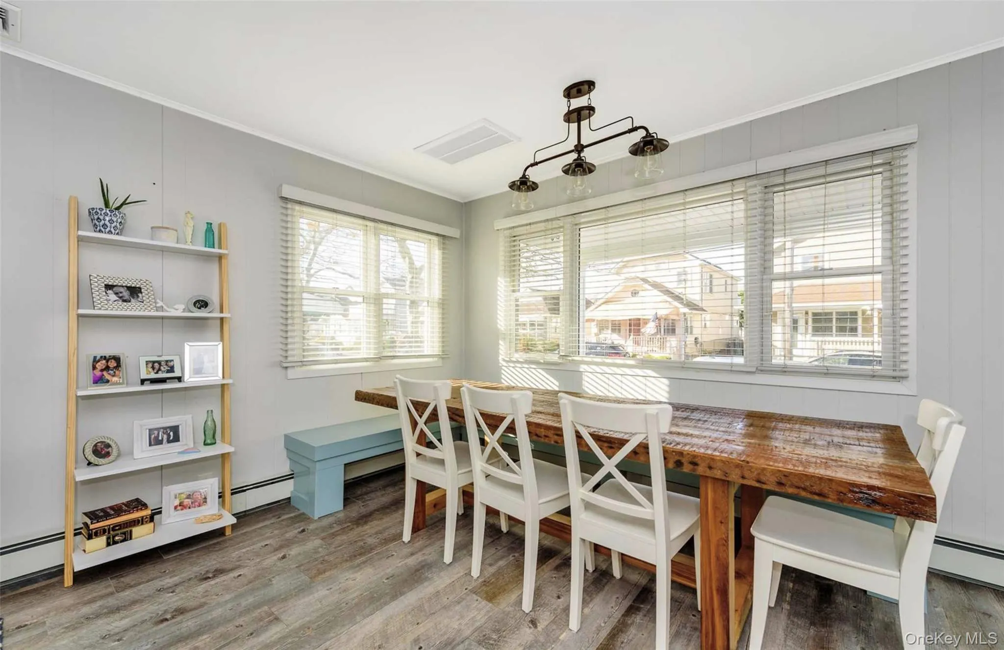 Dining area featuring hardwood / wood-style floors, breakfast area, plenty of natural light, and crown molding Dining area featuring hardwood / wood-style floors, breakfast area, plenty of natural light, and crown molding