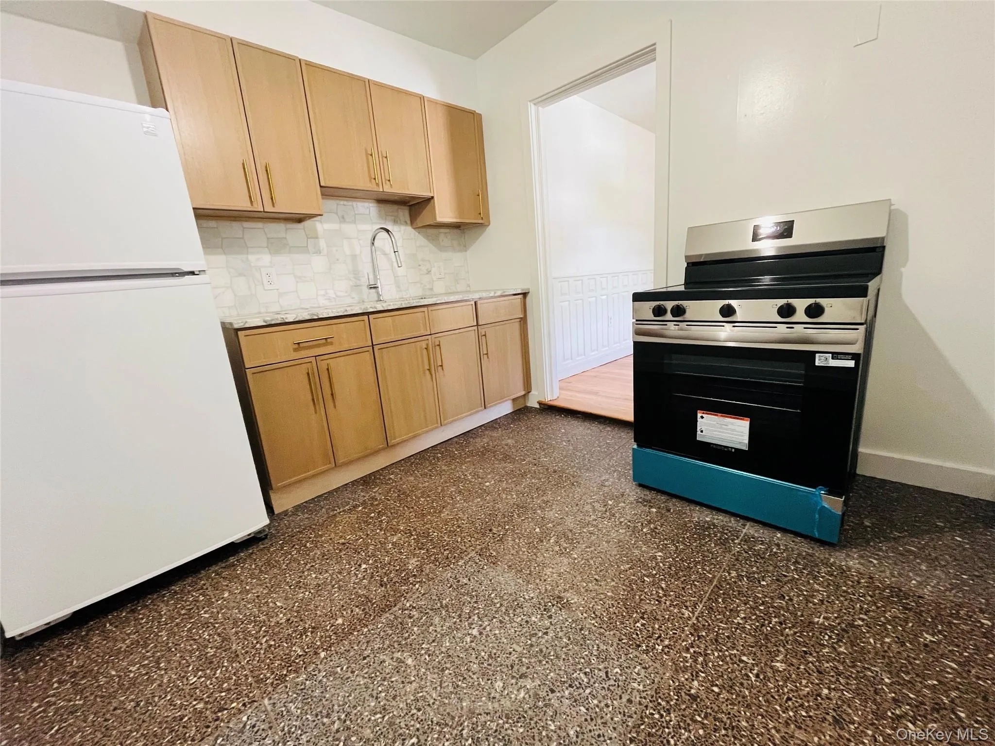 New floor, cabinets, sink, faucet, granite counter top, lighting, refrigerator, and electric stove. New floor, cabinets, sink, faucet, granite counter top, lighting, refrigerator, and electric stove.