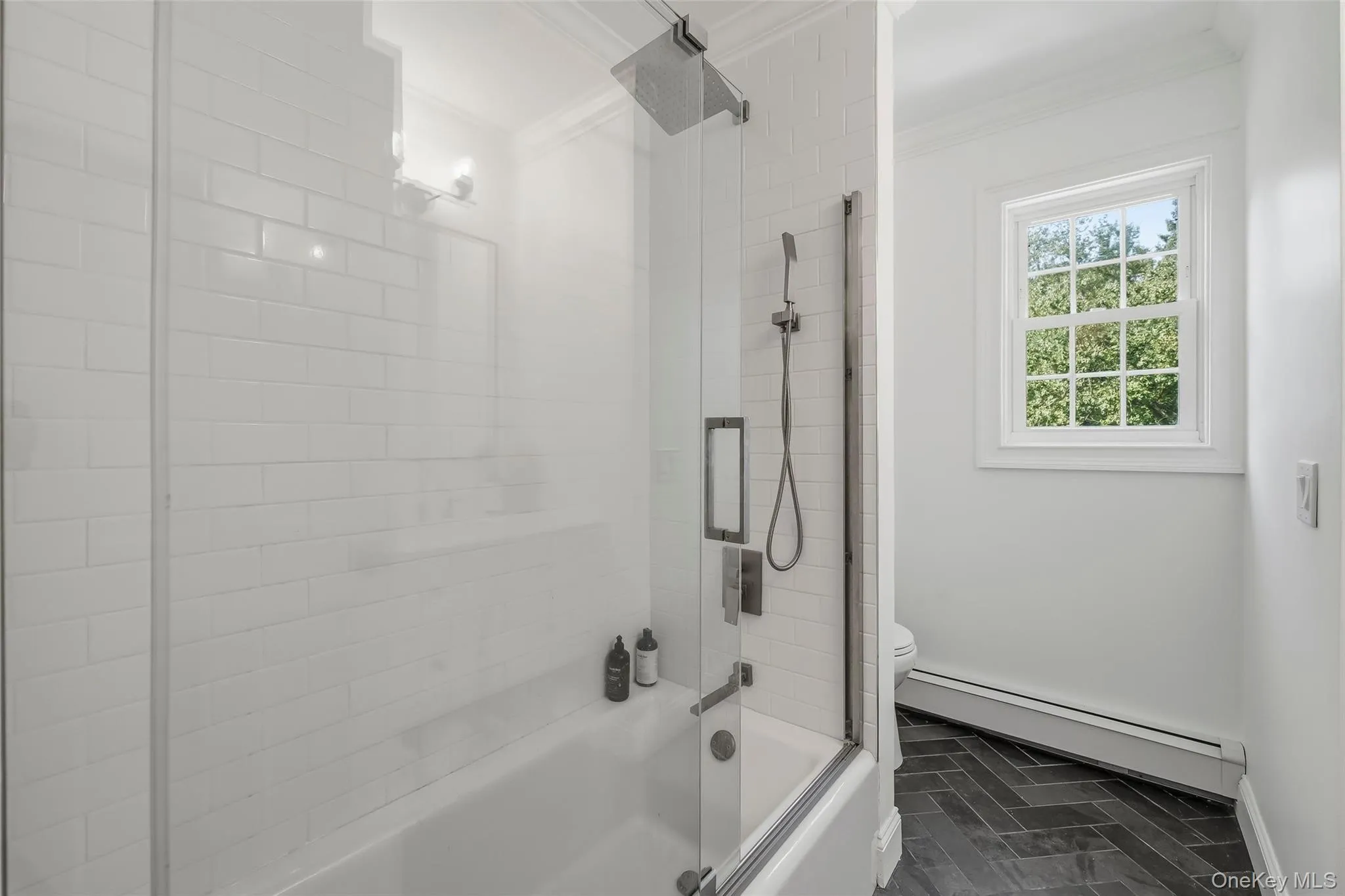 Another renovated bathroom with natural stone tile floor and marble vanity Another renovated bathroom with natural stone tile floor and marble vanity