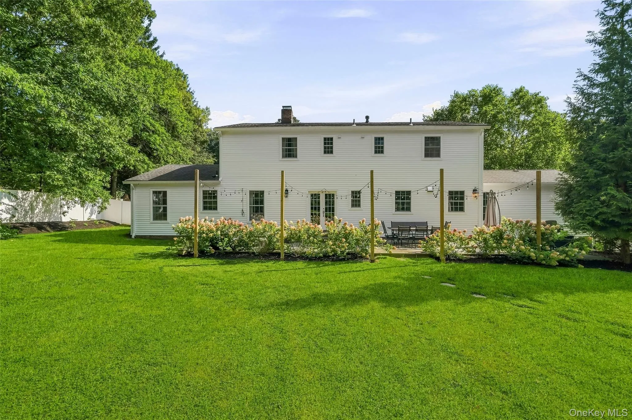Back of house with spacious manicured and fenced in yard Back of house with spacious manicured and fenced in yard