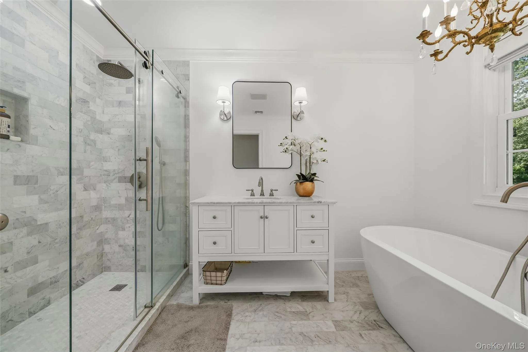 Stunning en suite primary bathroom with marble vanity and soaking tub. Stunning en suite primary bathroom with marble vanity and soaking tub.