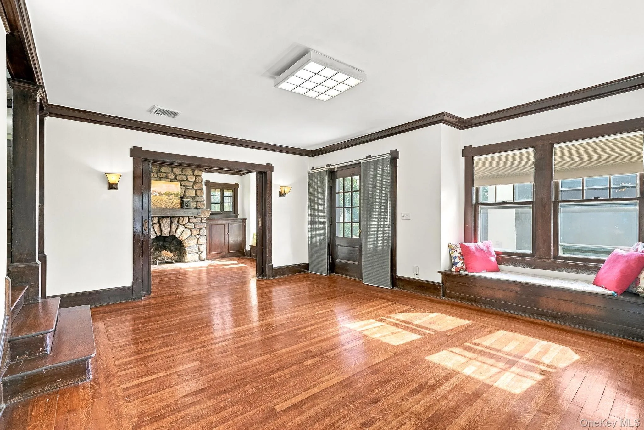 Living room with Original pocket doors to showcase stone fireplace Living room with Original pocket doors to showcase stone fireplace