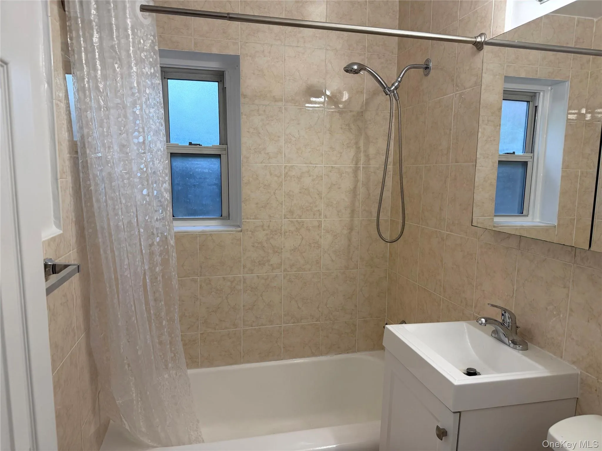 Updated bathroom with fully tiled bath/shower. New sink and shower fixture. Updated bathroom with fully tiled bath/shower. New sink and shower fixture.