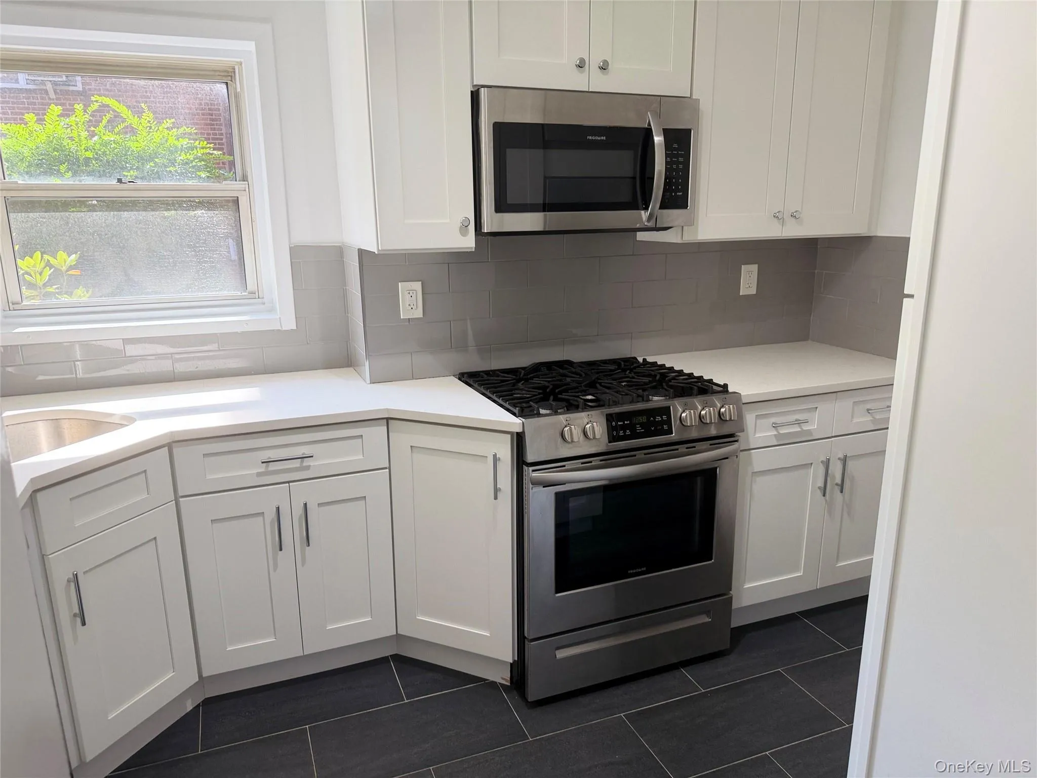 Fully updated kitchen features custom cabinetry, quartz counters, ceramic tile flooring and stainless steel appliances. Fully updated kitchen features custom cabinetry, quartz counters, ceramic tile flooring and stainless steel appliances.