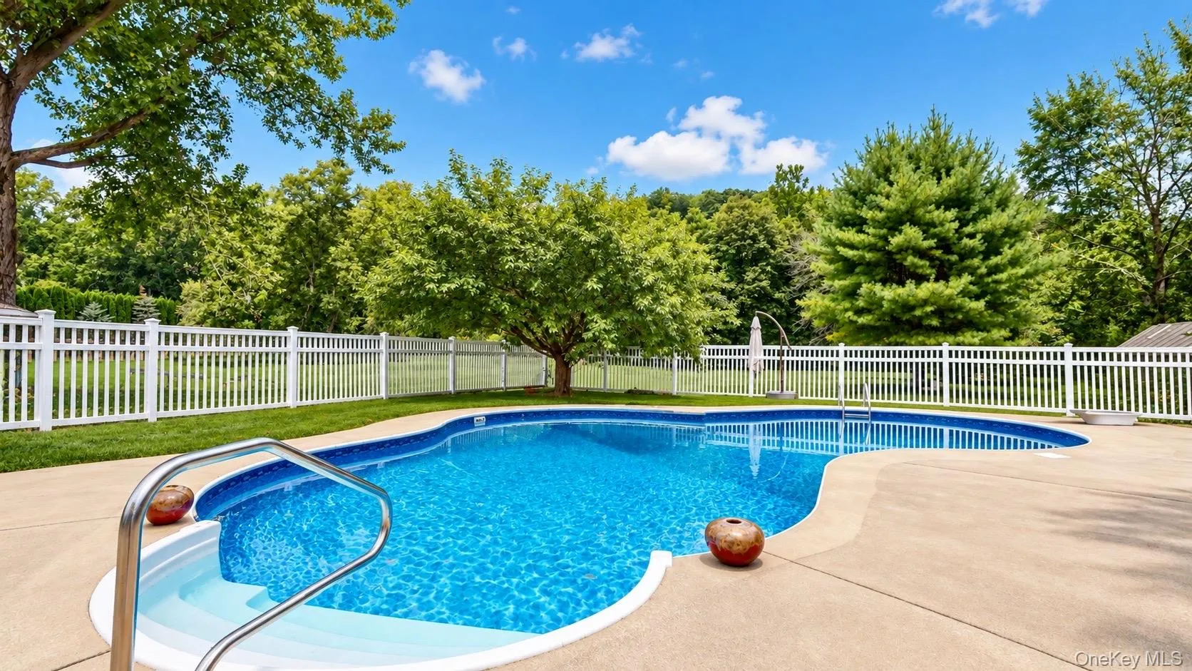 In-ground swimming pool with concrete surround In-ground swimming pool with concrete surround