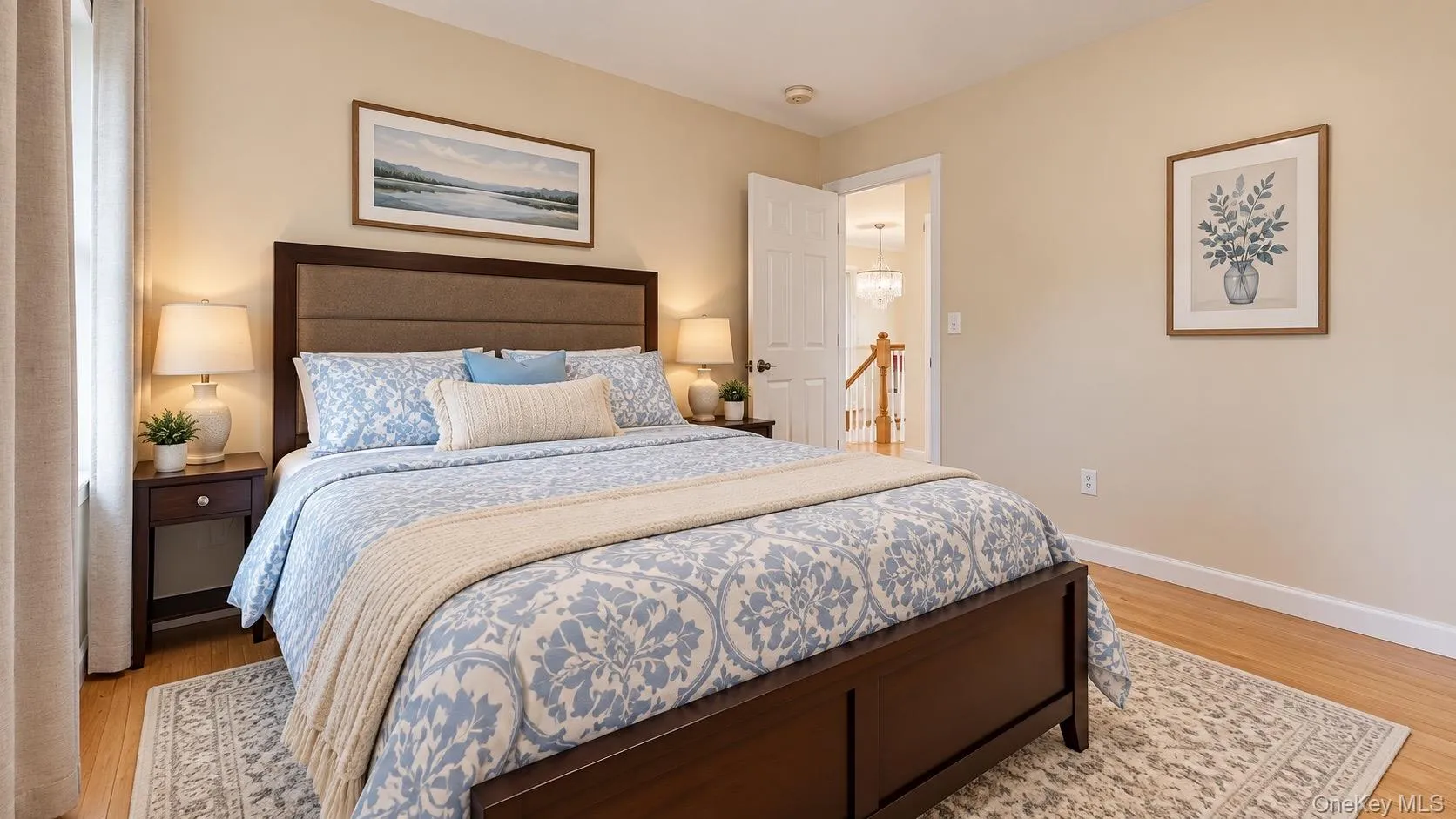 Wood-finish flooring with light-toned walls, a white-paneled door, and white trim Wood-finish flooring with light-toned walls, a white-paneled door, and white trim