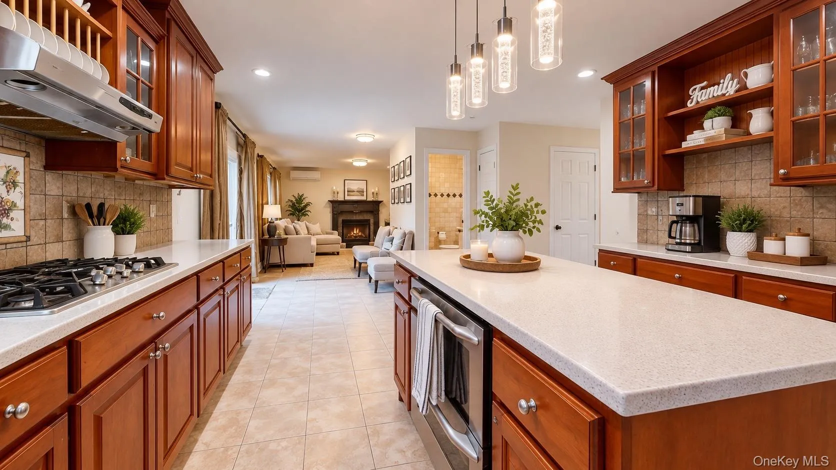 Kitchen featuring wood cabinetry, light-toned countertops, a gas range with stainless steel hood, and a built-in microwave Kitchen featuring wood cabinetry, light-toned countertops, a gas range with stainless steel hood, and a built-in microwave