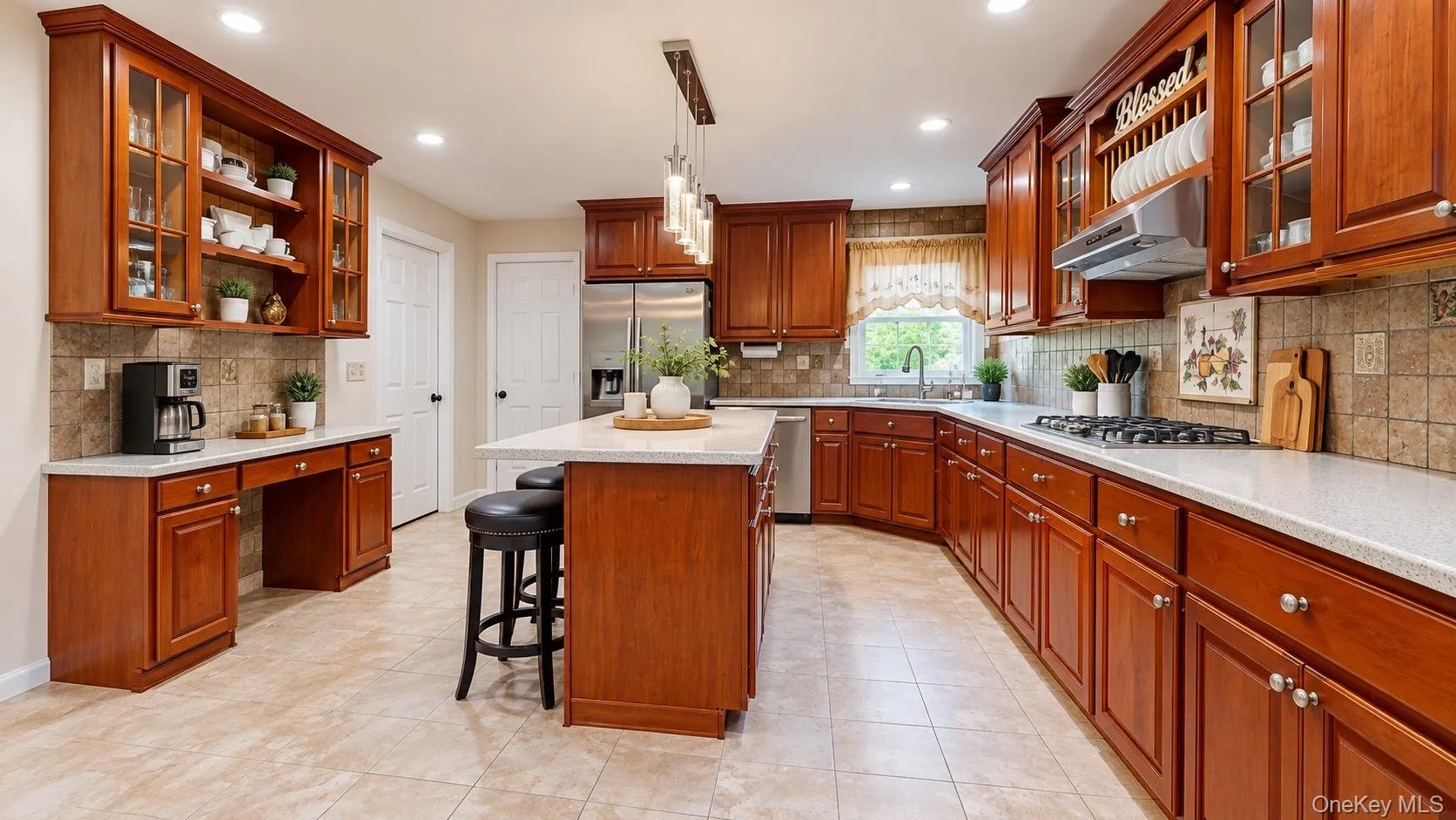 Wood cabinetry with glass-front uppers, stainless steel appliances, a center island with seating, a gas range, and recessed lighting Wood cabinetry with glass-front uppers, stainless steel appliances, a center island with seating, a gas range, and recessed lighting
