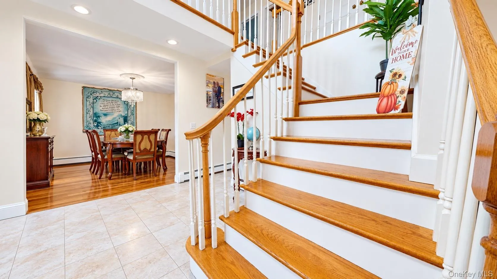 Curved staircase with wood treads and white risers, featuring a wood handrail and white balusters Curved staircase with wood treads and white risers, featuring a wood handrail and white balusters