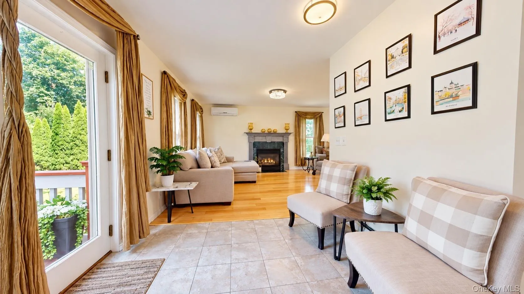 Tiled entry with recessed lighting leading to a living area with wood-finish flooring, fireplace, and sliding glass doors to outdoor space Tiled entry with recessed lighting leading to a living area with wood-finish flooring, fireplace, and sliding glass doors to outdoor space