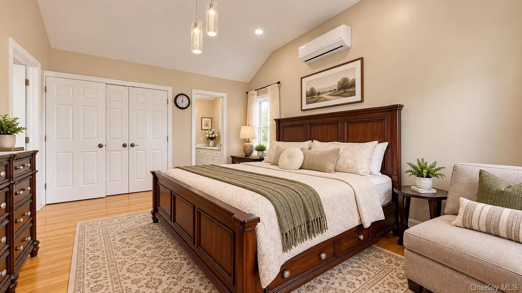 Vaulted ceiling, recessed lighting, wood-finish flooring, white bifold closet doors, and an attached compact wall-mounted air conditioning unit Vaulted ceiling, recessed lighting, wood-finish flooring, white bifold closet doors, and an attached compact wall-mounted air conditioning unit