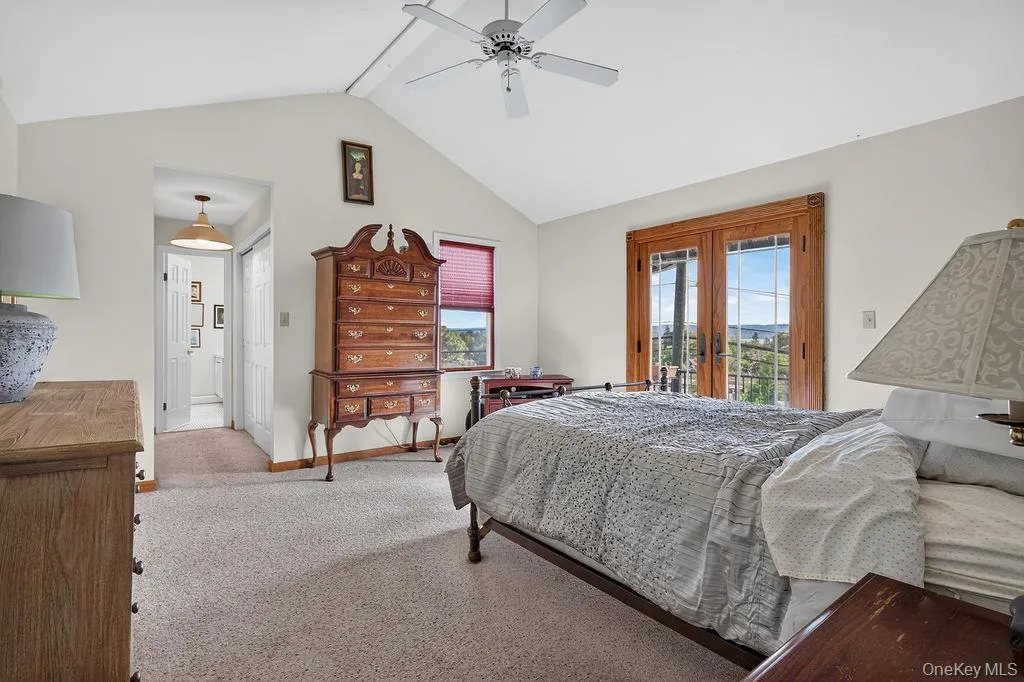 Vaulted ceilings in this lovely primary suite with Juliet balcony Vaulted ceilings in this lovely primary suite with Juliet balcony