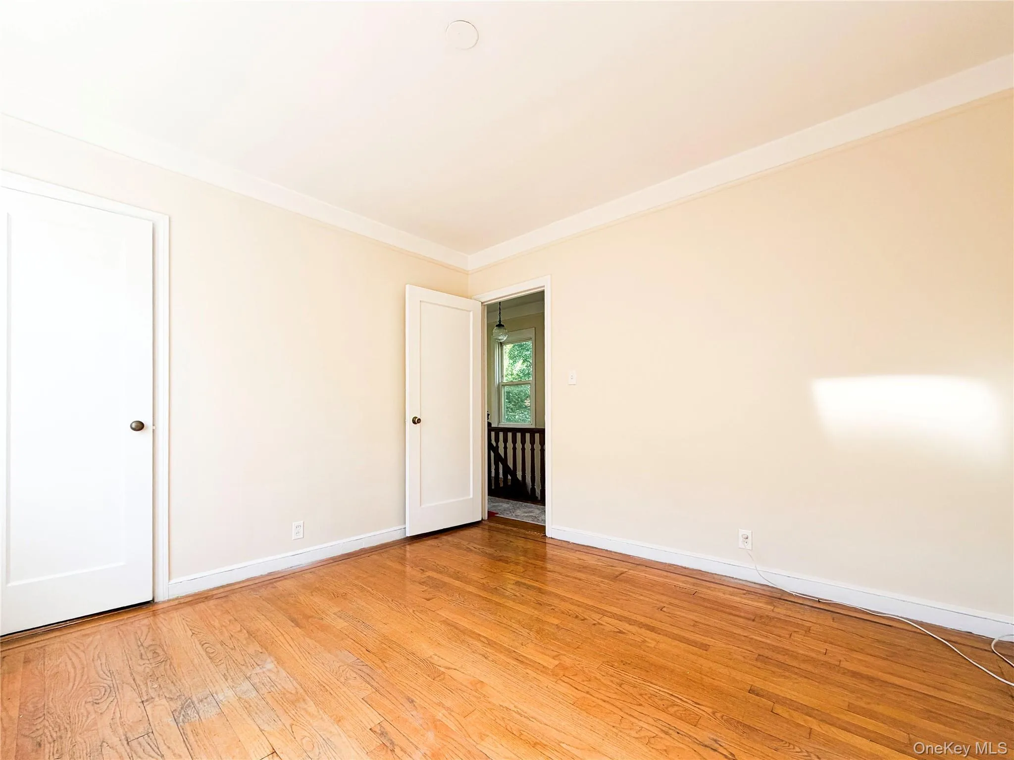 Hardwood flooring, painted interior doors, crown molding, and neutral wall tones Hardwood flooring, painted interior doors, crown molding, and neutral wall tones