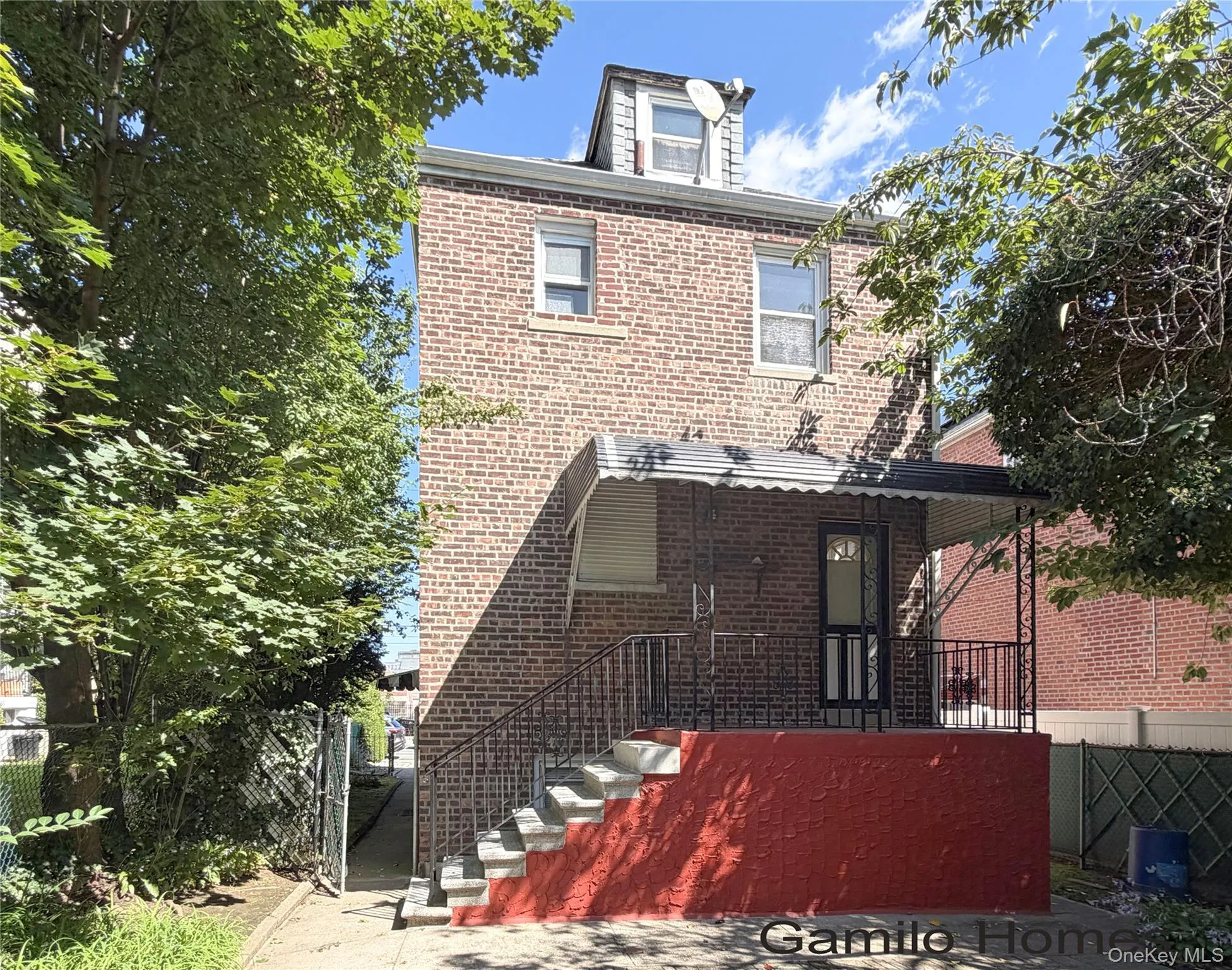 Brick exterior featuring multiple windows and a dormer Brick exterior featuring multiple windows and a dormer