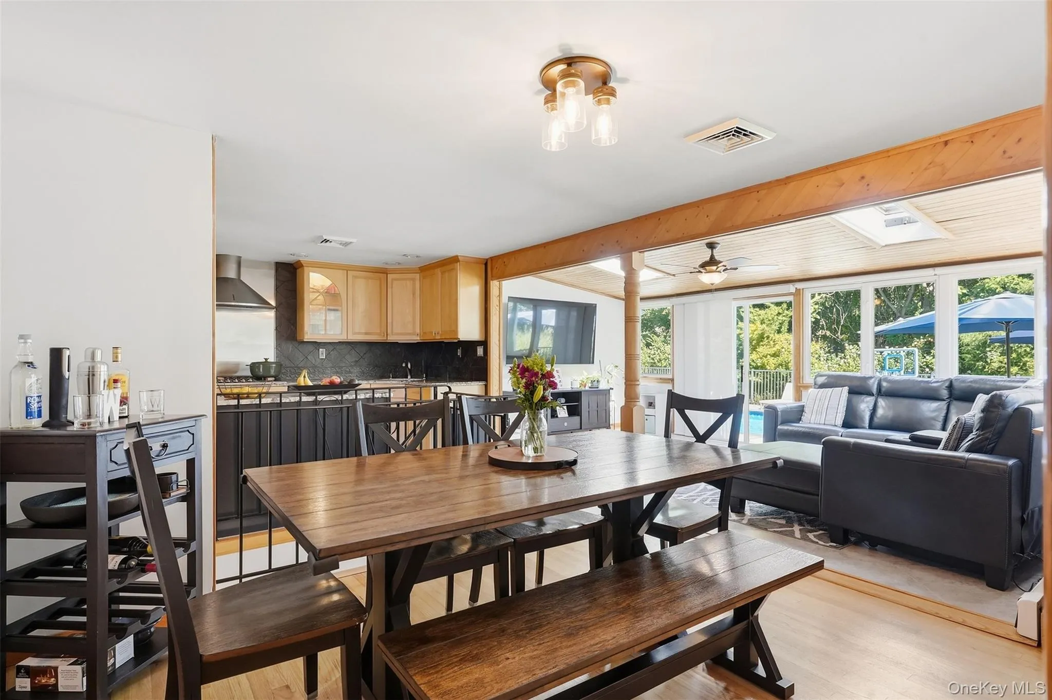 View from Dining Area facing Open Kitchen + Sunroom overlooking backyard/pool View from Dining Area facing Open Kitchen + Sunroom overlooking backyard/pool