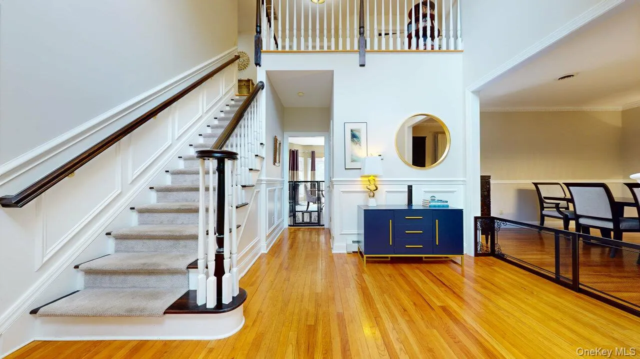 Gorgeous front entry with hardwood floors that have inlaid medallion, custom picture moulding on walls.. Gorgeous front entry with hardwood floors that have inlaid medallion, custom picture moulding on walls..