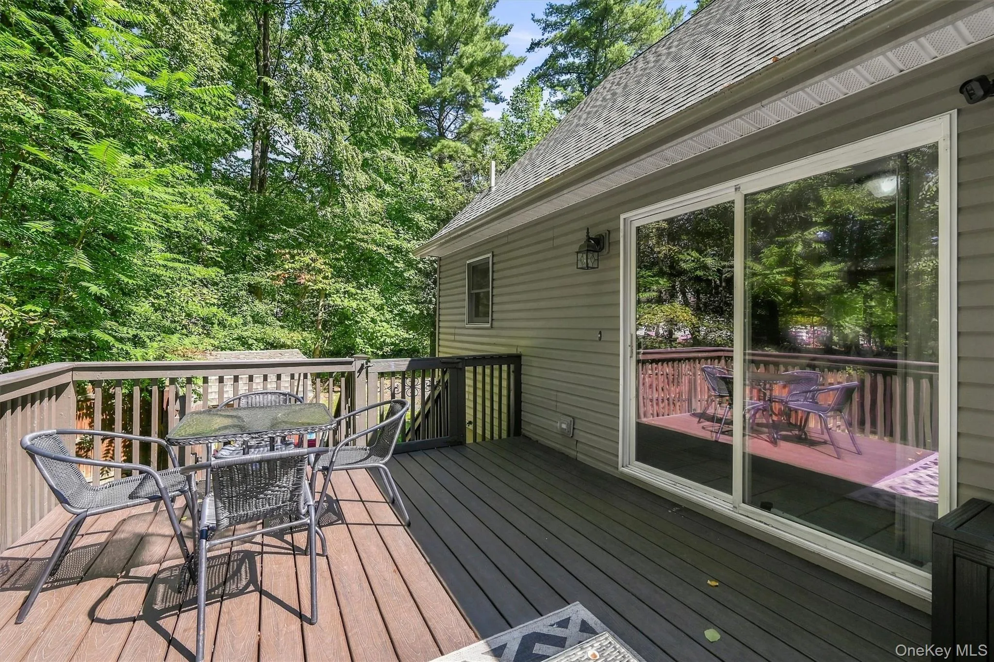 Multi-level deck featuring wood-finish and composite decking, complete with a full railing system Multi-level deck featuring wood-finish and composite decking, complete with a full railing system