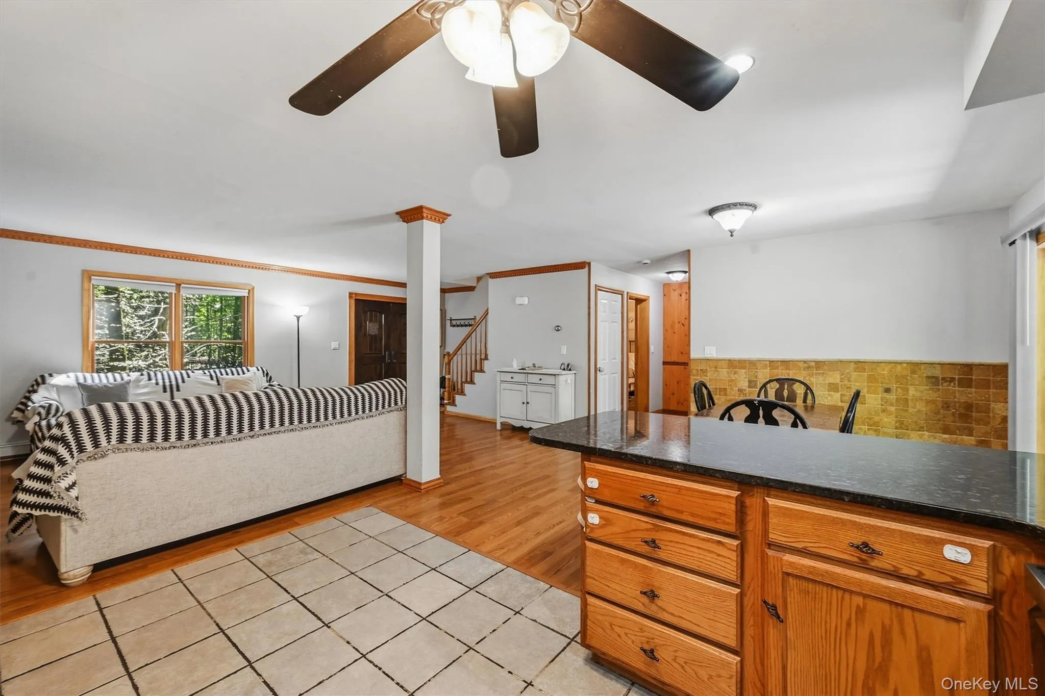Wood-finish flooring, recessed lighting, and a ceiling fan Wood-finish flooring, recessed lighting, and a ceiling fan
