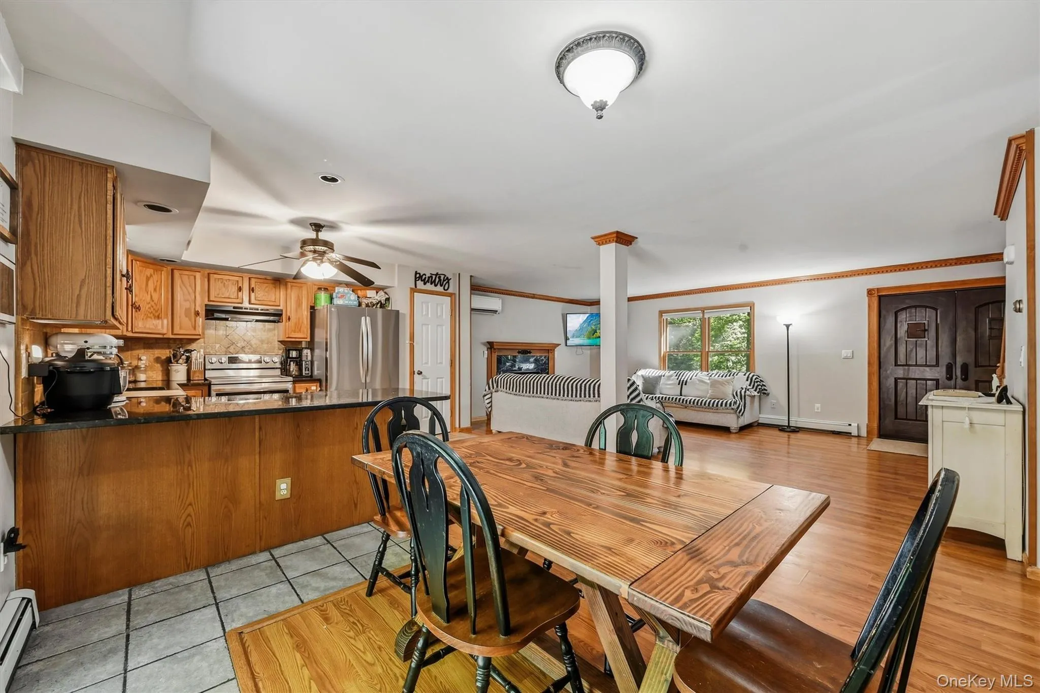 Kitchen with wood cabinetry, dark countertops, and stainless steel appliances Kitchen with wood cabinetry, dark countertops, and stainless steel appliances